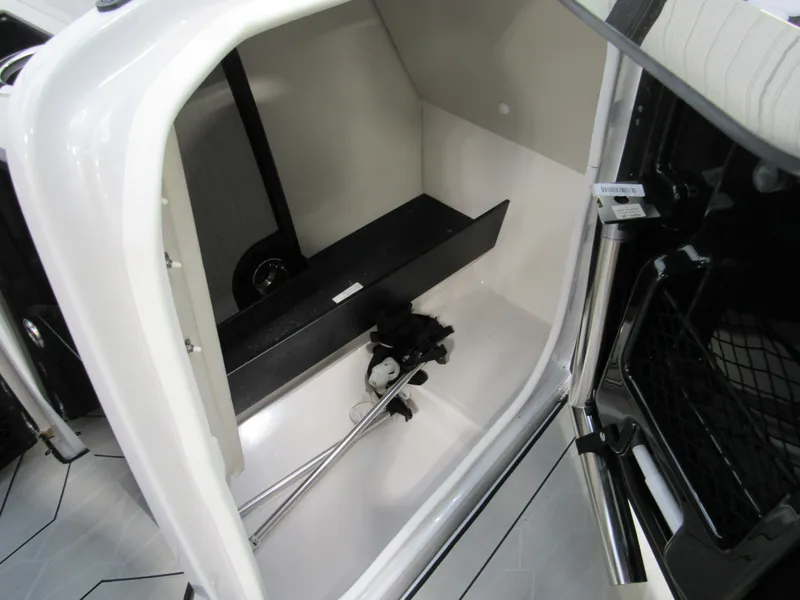 Slide: The Image of 2024 Yamaha Boats 255XD storage compartment with sleek interior design. - 5