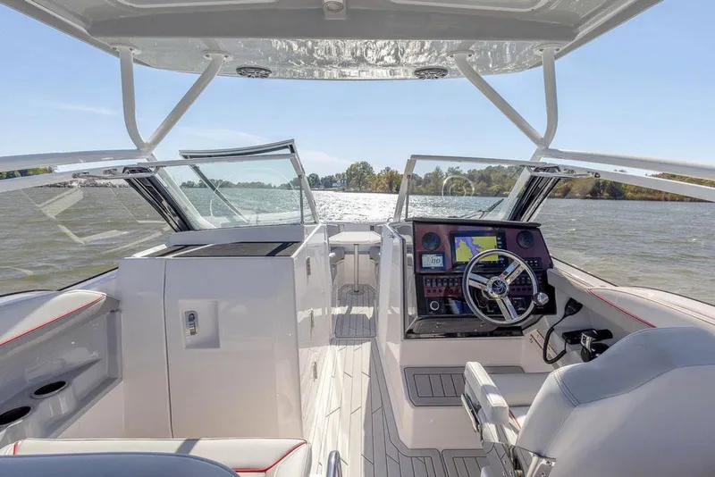 Slide: The Image of Manufacturer Provided Image: 2025 Solara S-250 DC boat interior with modern dashboard and steering on open water. - 3