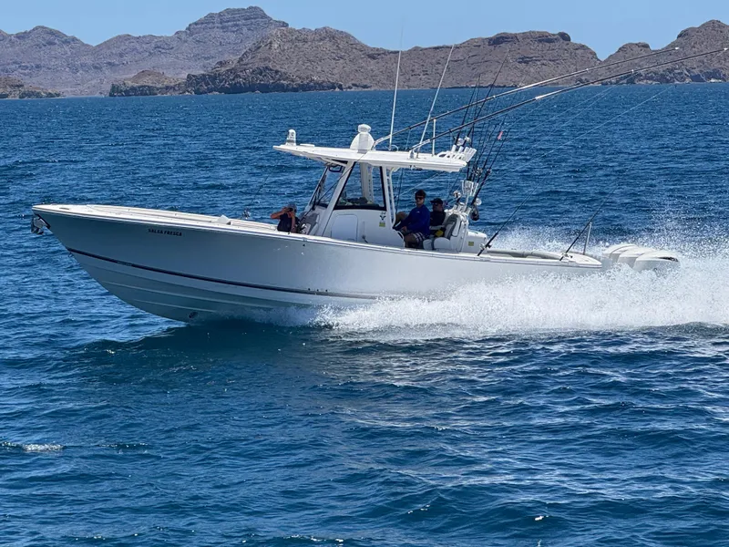 The Image of 2020 Regulator 34 Center Console boat cruising on blue ocean waters. - 1