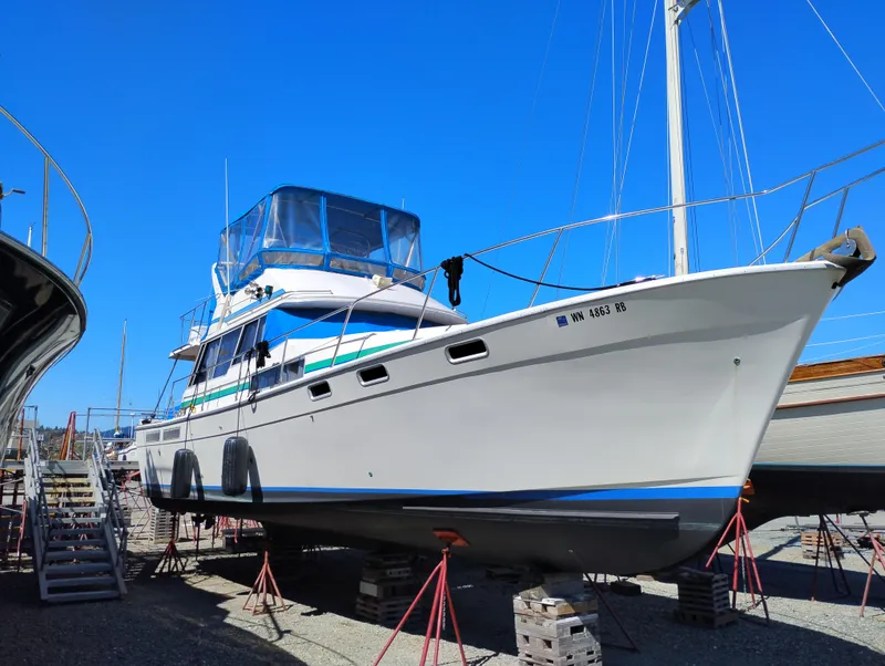 The Image of 1986 Bayliner 3870 Motoryacht on stands, clear blue sky background. - 0