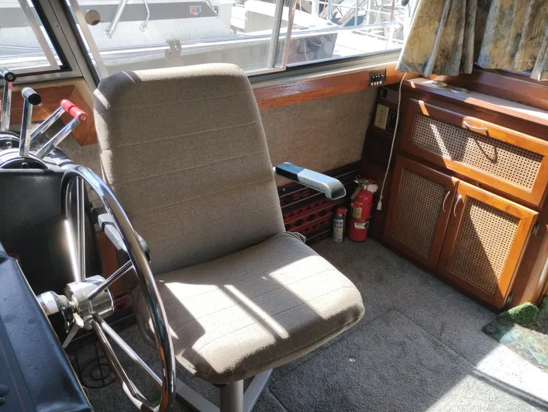 Slide: The Image of Interior of 1986 Bayliner 3870 Motoryacht helm with steering wheel and control panel. - 12