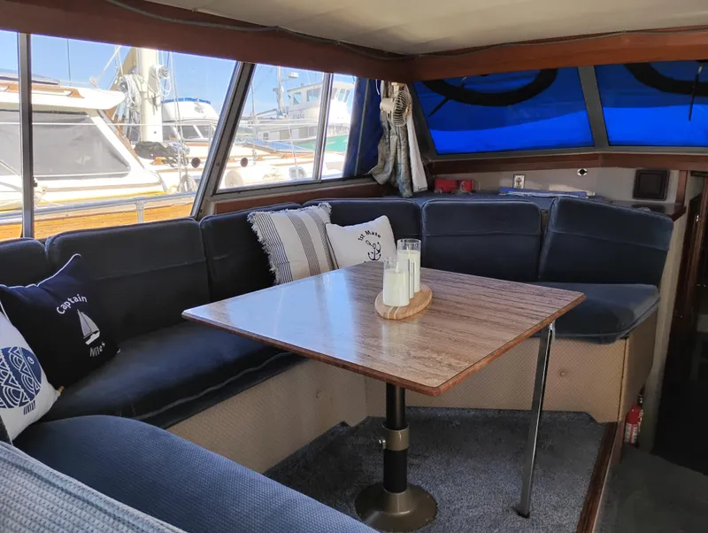 Slide: The Image of Interior of 1986 Bayliner 3870 Motoryacht with cozy seating and nautical-themed decor. - 13
