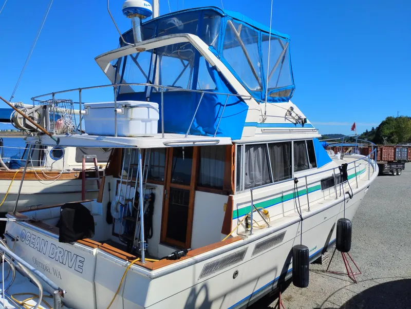 Slide: The Image of 1986 Bayliner 3870 Motoryacht with blue canopy docked in Olympia, WA. - 2