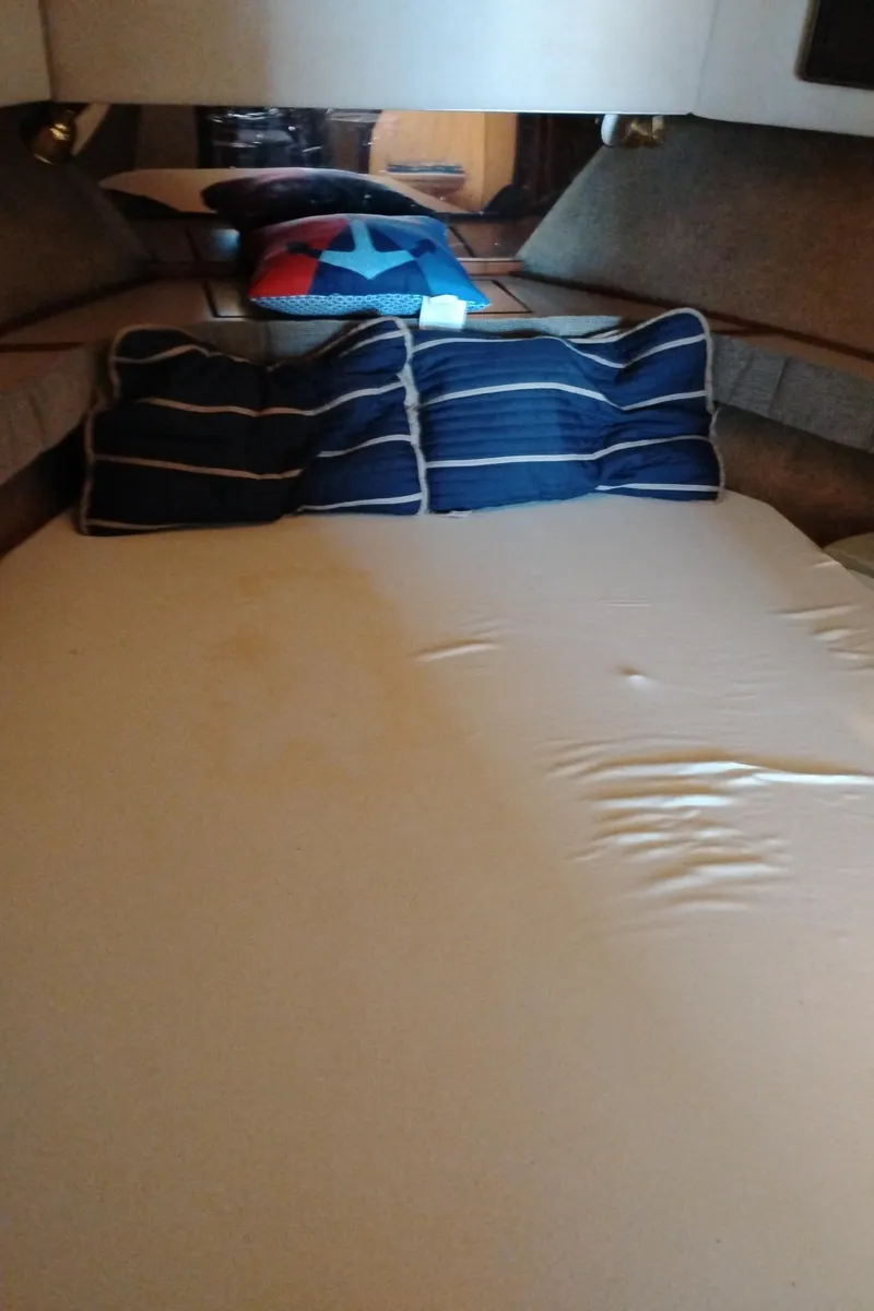 Slide: The Image of Cozy cabin interior of 1986 Bayliner 3870 Motoryacht with striped pillows. - 21