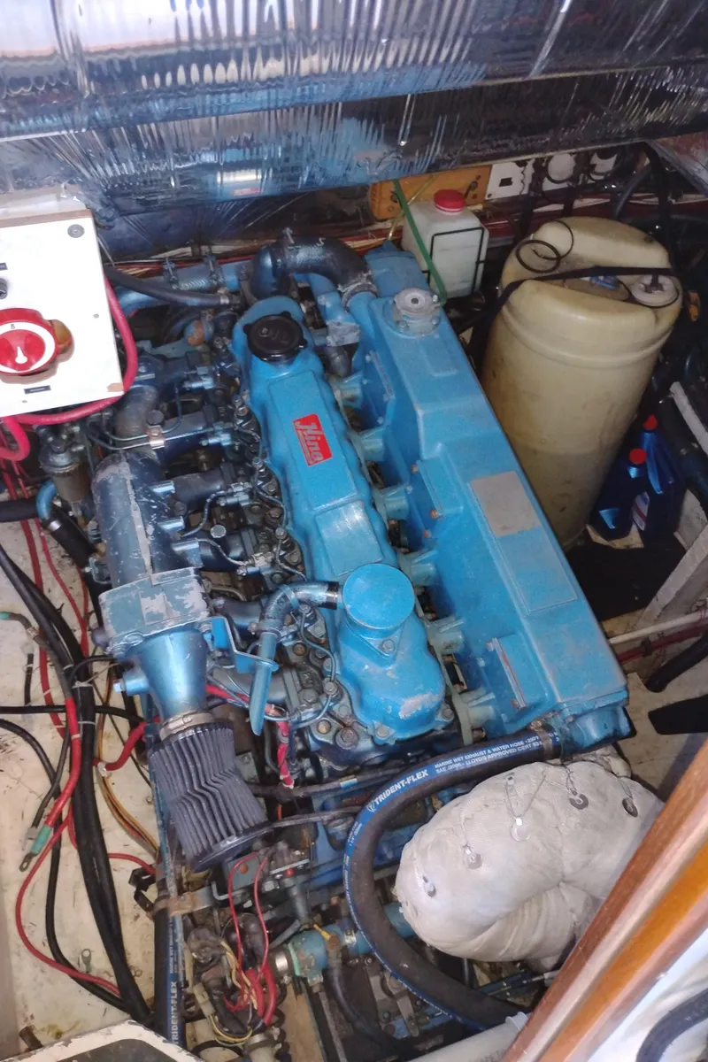 Slide: The Image of Engine room of 1986 Bayliner 3870 Motoryacht with blue marine engine components. - 26