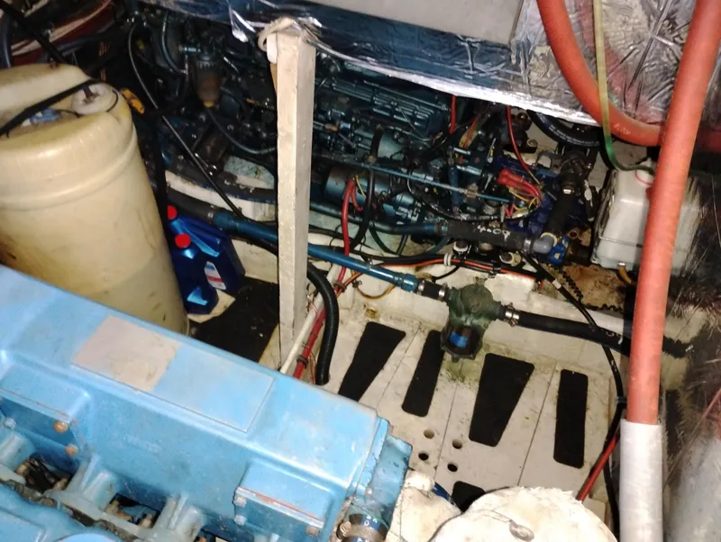 Slide: The Image of Engine room of 1986 Bayliner 3870 Motoryacht, showcasing mechanical components and wiring. - 27