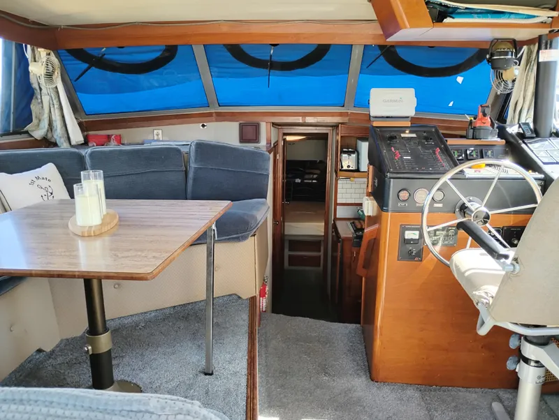 Slide: The Image of Interior of 1986 Bayliner 3870 Motoryacht with helm, seating, and table. - 8