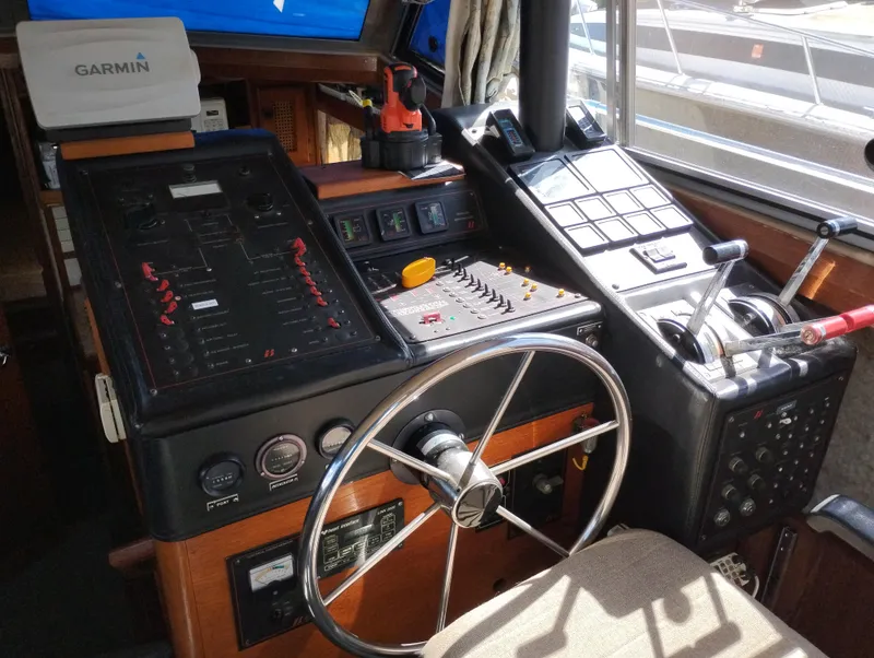 Slide: The Image of Interior helm of 1986 Bayliner 3870 Motoryacht with steering wheel and control panels. - 9