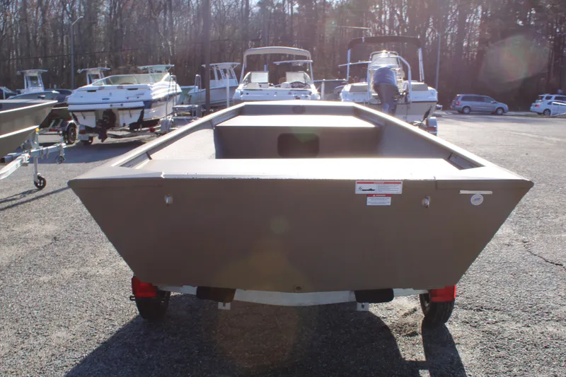 Slide: The Image of 2025 G3 Gator Tough 1652 VBW boat on trailer, parked outdoors in a lot. - 4