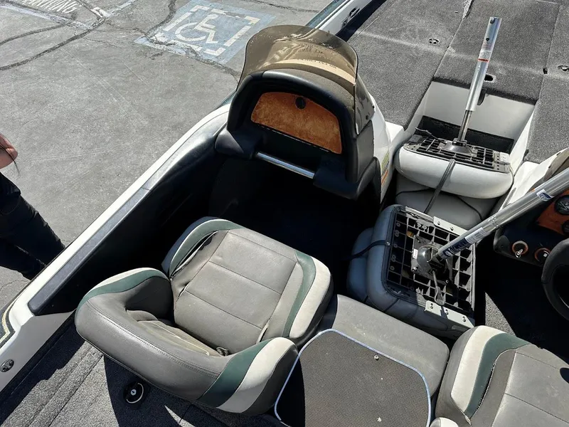 Slide: The Image of 1999 Fisher 21 FX DC boat interior with seating and steering components. - 11