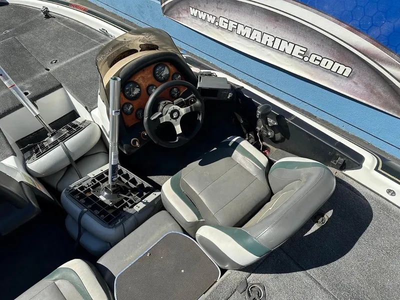 Slide: The Image of 1999 Fisher 21 FX DC boat interior with steering wheel and seating. - 12