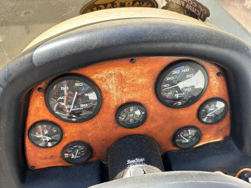 Slide: The Image of Dashboard of a 1999 Fisher 21 FX DC boat with speedometer and gauges. - 15