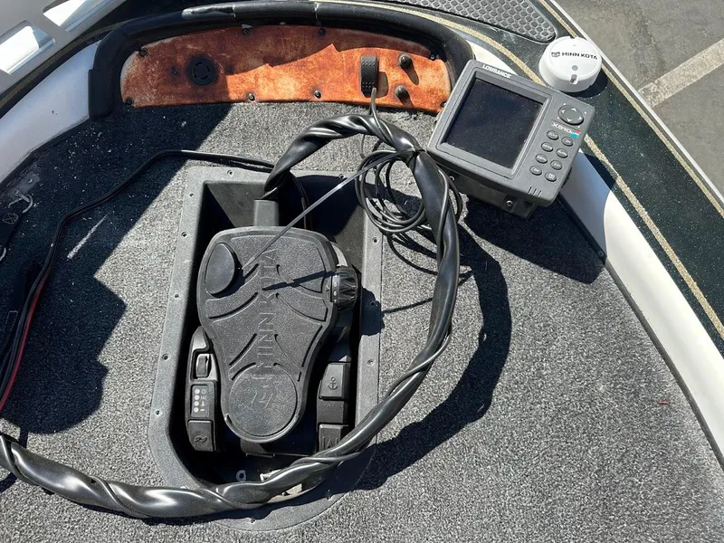 Slide: The Image of 1999 Fisher 21 FX DC boat dashboard with Lowrance electronics and Minn Kota foot pedal. - 22