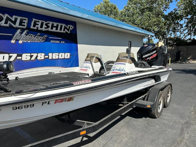 Slide: The Image of 1999 Fisher 21 FX DC boat on trailer, parked outside a marine shop. - 6