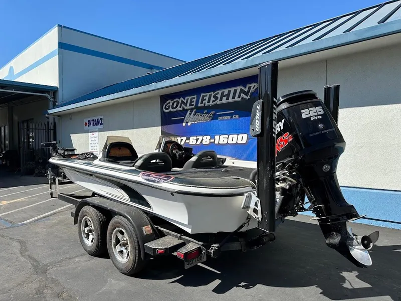Slide: The Image of 1999 Fisher 21 FX DC boat with Mercury 225 Pro XS engine on trailer. - 8