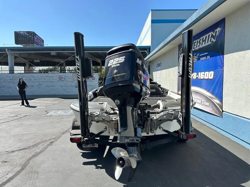 Slide: The Image of 1999 Fisher 21 FX DC boat with Mercury 225 Pro motor in parking lot. - 9