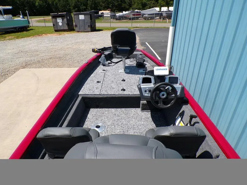 Slide: The Image of 2025 Tracker Pro Team 175 TF® boat interior with steering console and seating. - 11