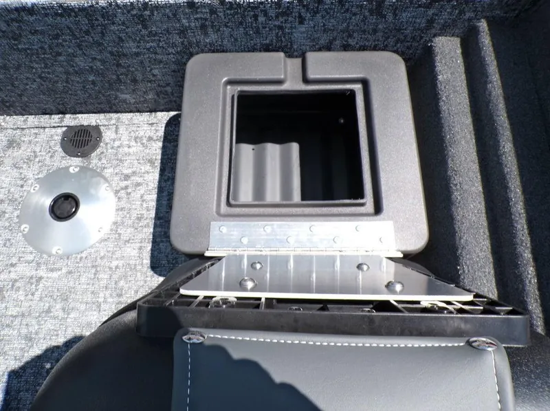 Slide: The Image of 2025 Tracker Pro Team 175 TF® boat storage compartment, open lid, gray interior. - 21