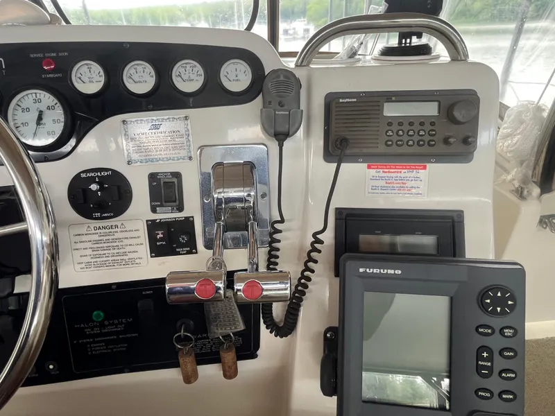Slide: The Image of 1999 Silverton 392 Aft Cabin helm with gauges, radio, and navigation equipment. - 10