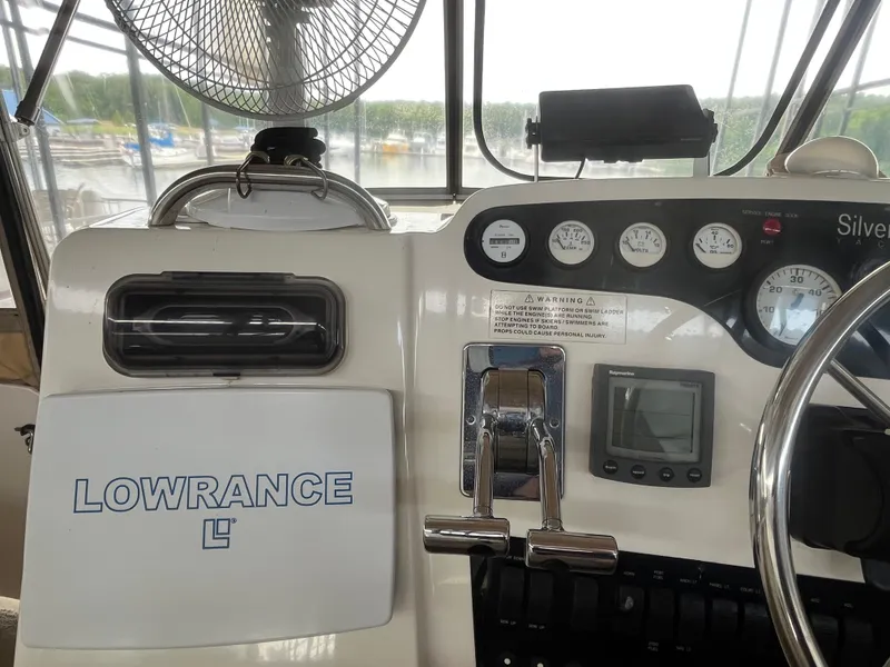 Slide: The Image of 1999 Silverton 392 Aft Cabin helm with Lowrance equipment and gauges. - 11