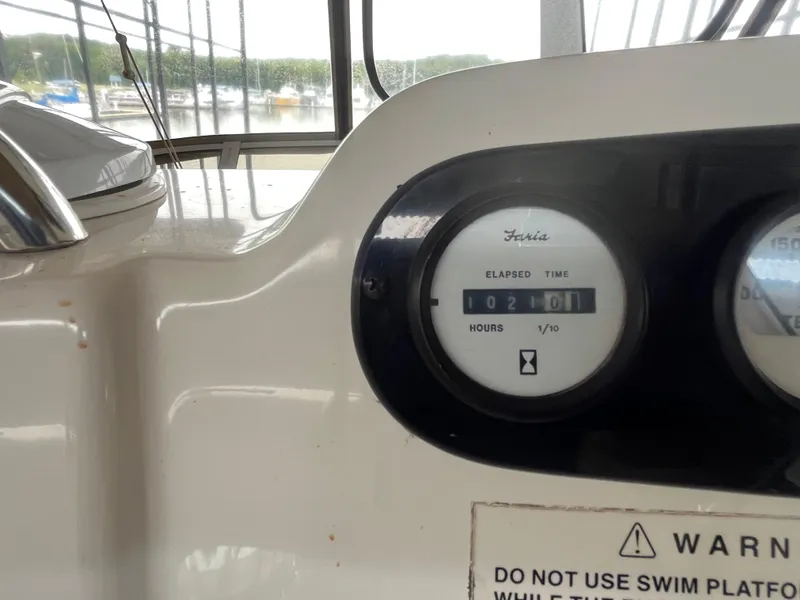 Slide: The Image of 1999 Silverton 392 Aft Cabin boat dashboard with elapsed time gauge reading 1021 hours. - 12