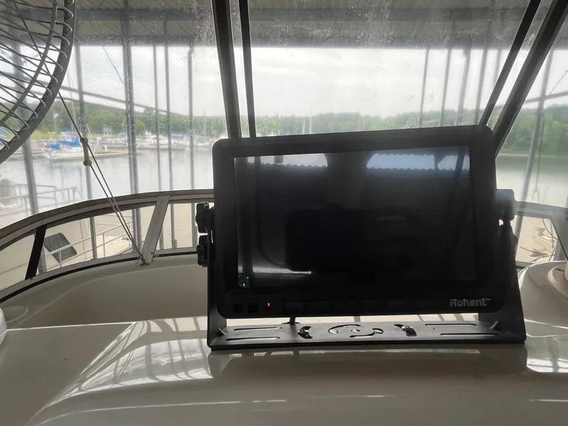 Slide: The Image of 1999 Silverton 392 Aft Cabin helm with navigation screen and marina view. - 13