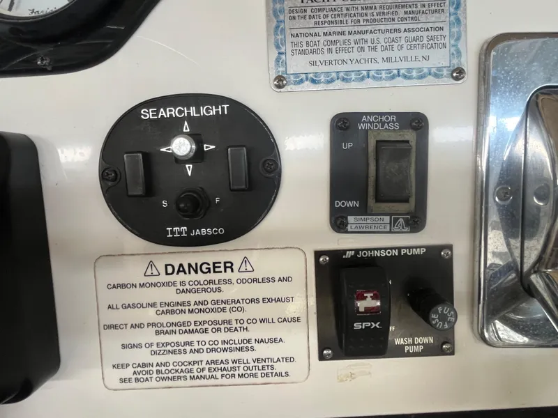 Slide: The Image of Control panel of a 1999 Silverton 392 Aft Cabin with searchlight and anchor windlass switches. - 16