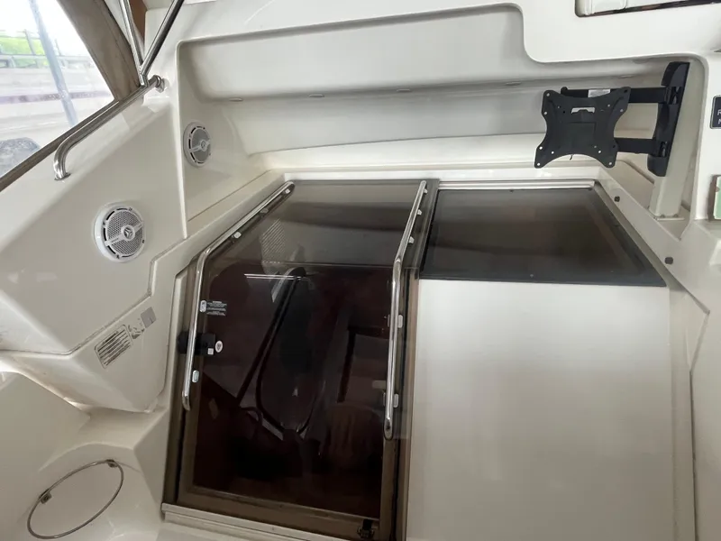 Slide: The Image of 1999 Silverton 392 Aft Cabin interior with hatch, speakers, and TV mount. - 22