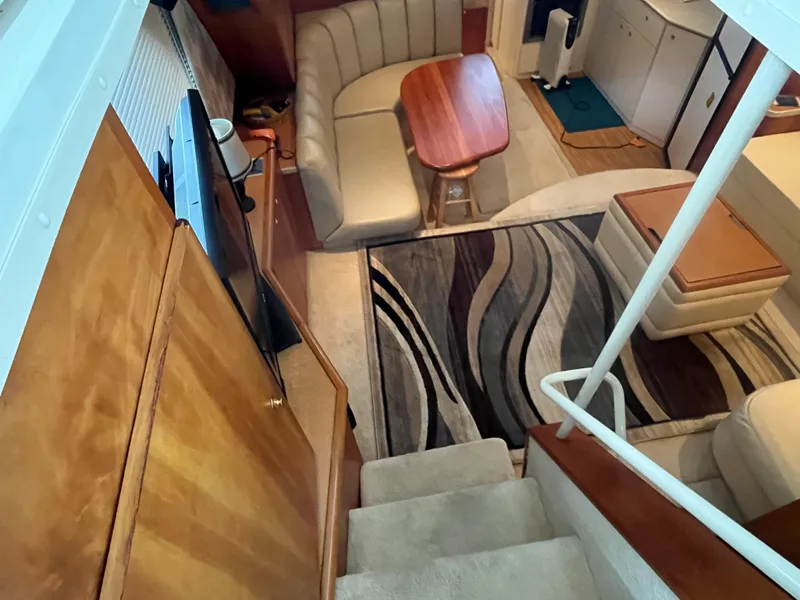 Slide: The Image of Interior of 1999 Silverton 392 Aft Cabin with cozy seating and modern decor. - 23