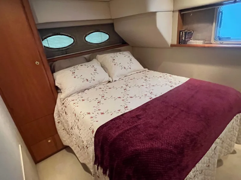 Slide: The Image of Cozy bedroom in 1999 Silverton 392 Aft Cabin with floral bedding and porthole windows. - 27