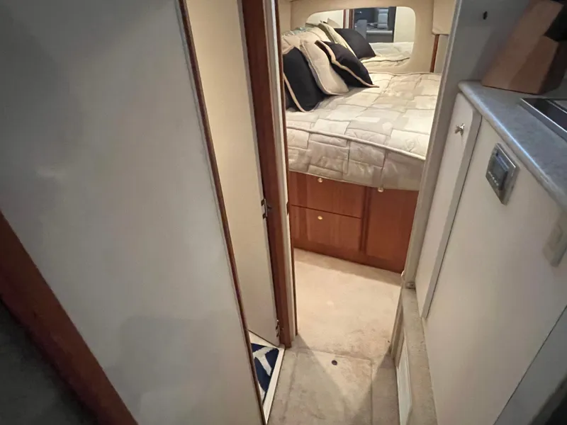 Slide: The Image of 1999 Silverton 392 Aft Cabin interior with cozy bed and wooden cabinetry. - 30