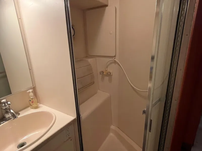 Slide: The Image of 1999 Silverton 392 Aft Cabin bathroom with sink, shower, and soap dispenser. - 32