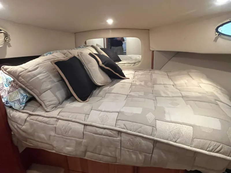 Slide: The Image of Cozy bedroom in 1999 Silverton 392 Aft Cabin yacht with plush bedding and soft lighting. - 34