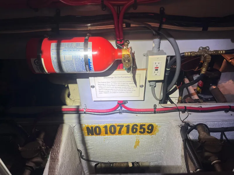 Slide: The Image of Engine room of 1999 Silverton 392 Aft Cabin with fire extinguisher and wiring. - 39