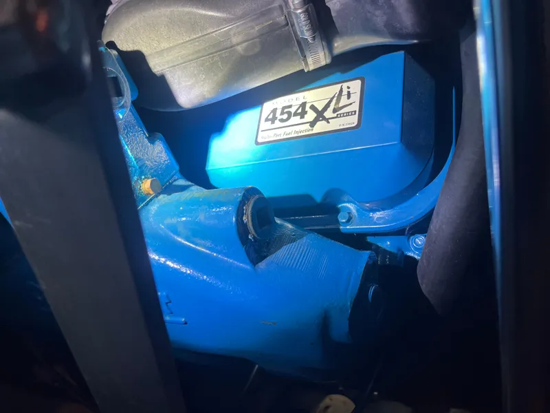 Slide: The Image of Close-up of a 1999 Silverton 392 Aft Cabin engine, featuring a blue 454 XL model. - 40