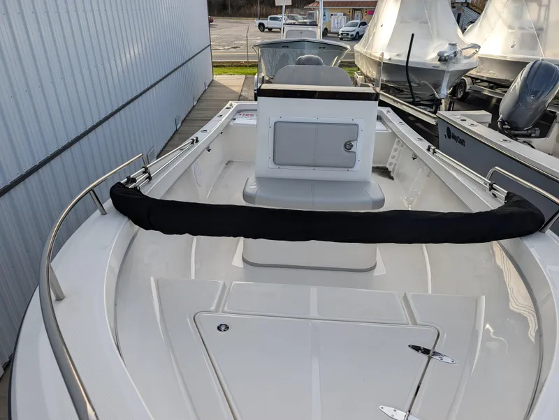 Slide: The Image of 2024 May-Craft 1900CC boat, white deck, center console, docked at marina. - 12