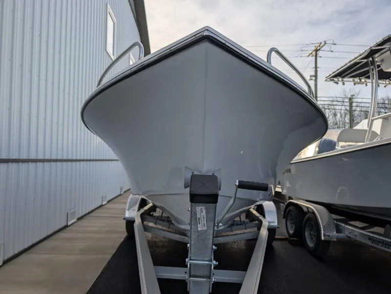 Slide: The Image of 2024 May-Craft 1900CC boat on trailer, front view, parked near building. - 3