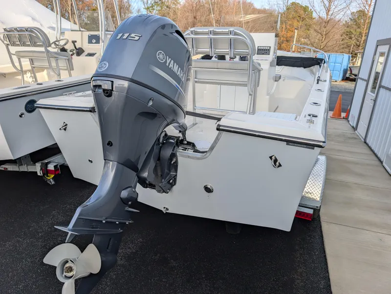 Slide: The Image of 2024 May-Craft 1900CC boat with Yamaha 115 outboard motor, parked outdoors. - 8