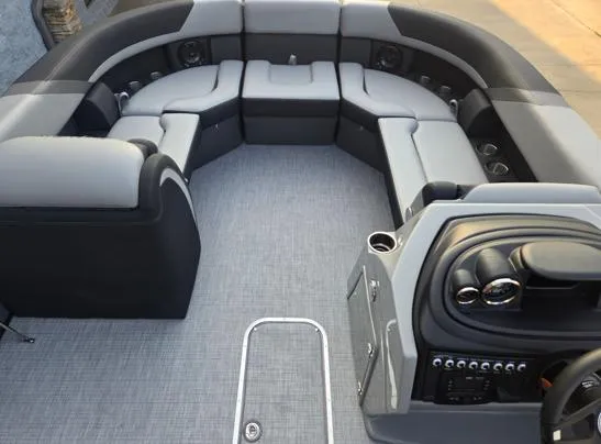 Slide: The Image of 2026 South Bay S224RS pontoon boat interior with gray seating and modern dashboard. - 6