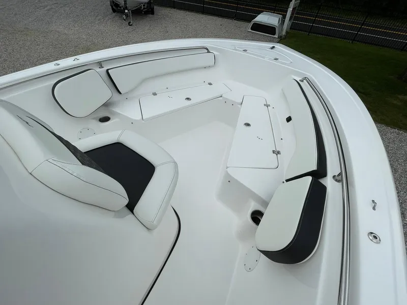 Slide: The Image of 2024 Tidewater 198 CC Adventure boat interior with white cushioned seating and storage compartments. - 11