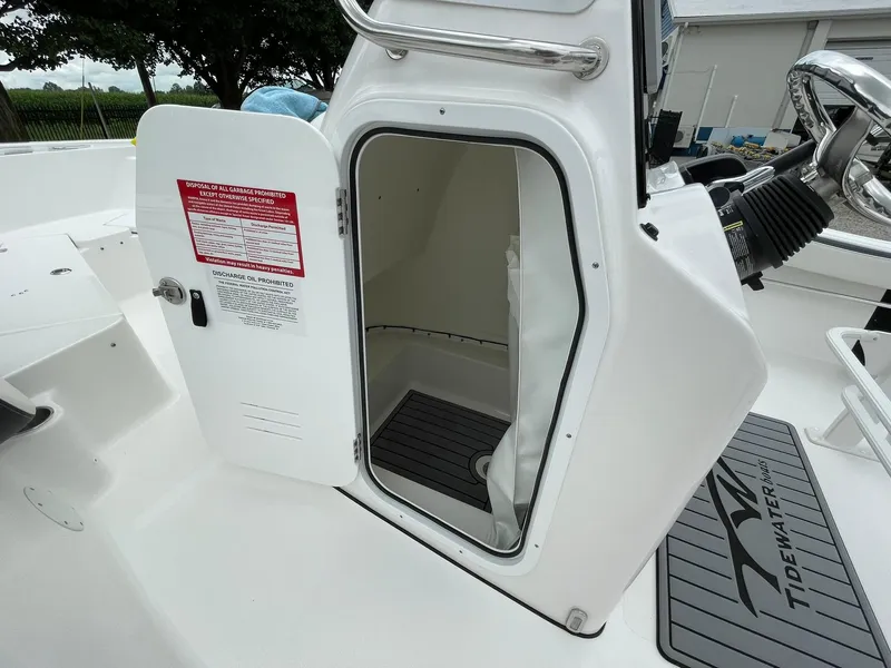 Slide: The Image of 2024 Tidewater 198 CC Adventure boat with open storage compartment and visible safety instructions. - 17