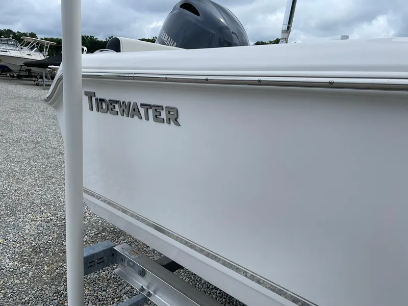 Slide: The Image of 2024 Tidewater 198 CC Adventure boat side view with Yamaha engine. - 2