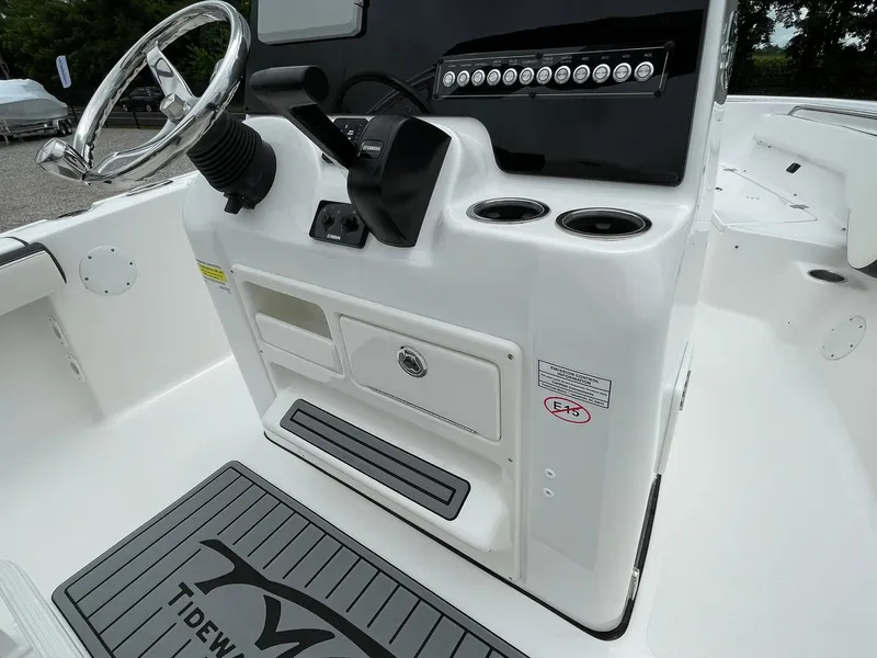 Slide: The Image of 2024 Tidewater 198 CC Adventure boat console with steering wheel and controls. - 22