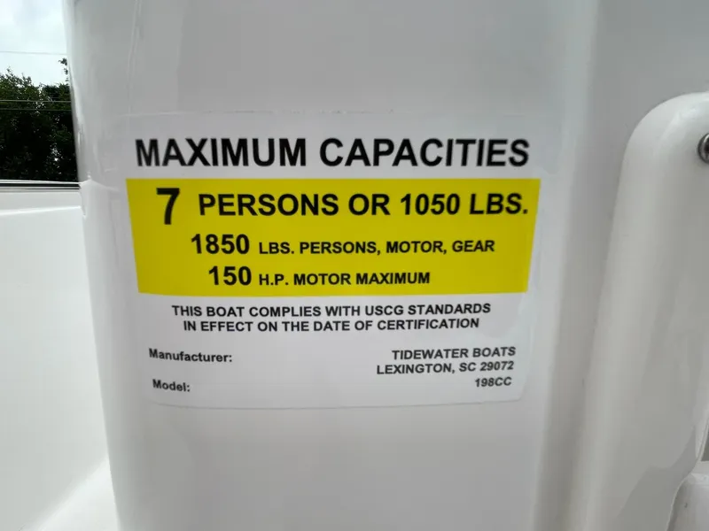 Slide: The Image of 2024 Tidewater 198 CC Adventure capacity label: 7 persons, 1050 lbs, 150 HP motor max. - 23