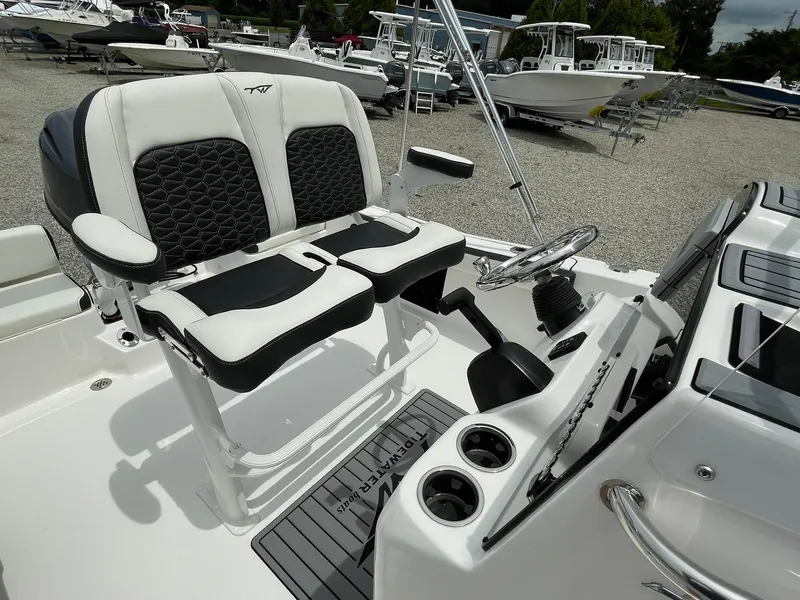 Slide: The Image of 2024 Tidewater 198 CC Adventure boat interior with dual seats and steering console. - 26