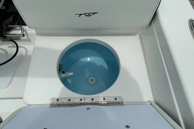 Slide: The Image of 2024 Tidewater 198 CC Adventure boat livewell with blue interior. - 29