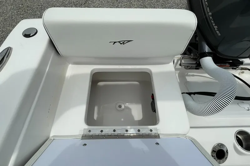 Slide: The Image of 2024 Tidewater 198 CC Adventure boat with open storage compartment and engine details. - 30