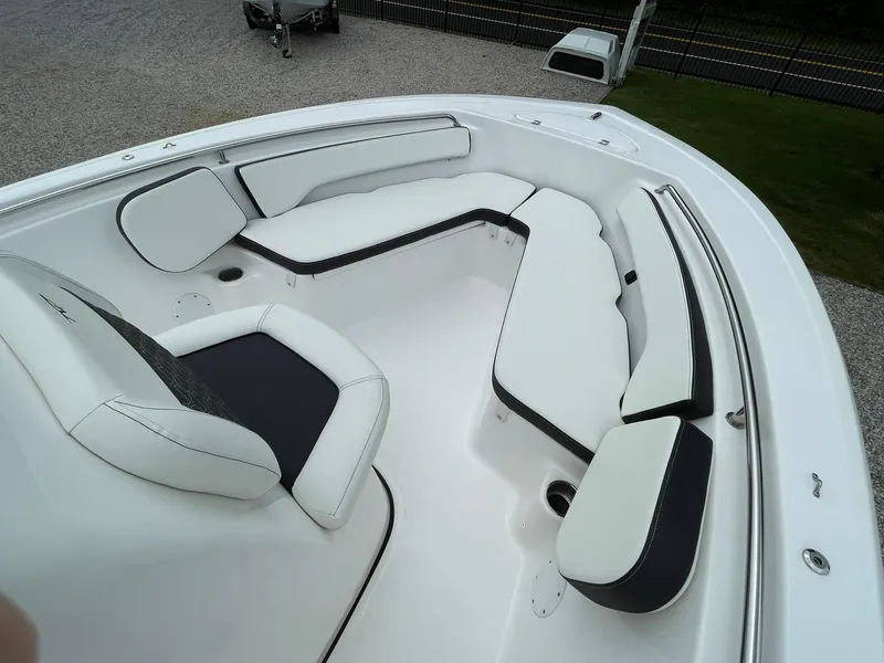 Slide: The Image of 2024 Tidewater 198 CC Adventure boat with white cushioned seating and sleek design. - 5