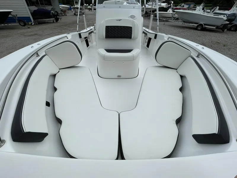 Slide: The Image of 2024 Tidewater 198 CC Adventure boat interior with white cushioned seating. - 6