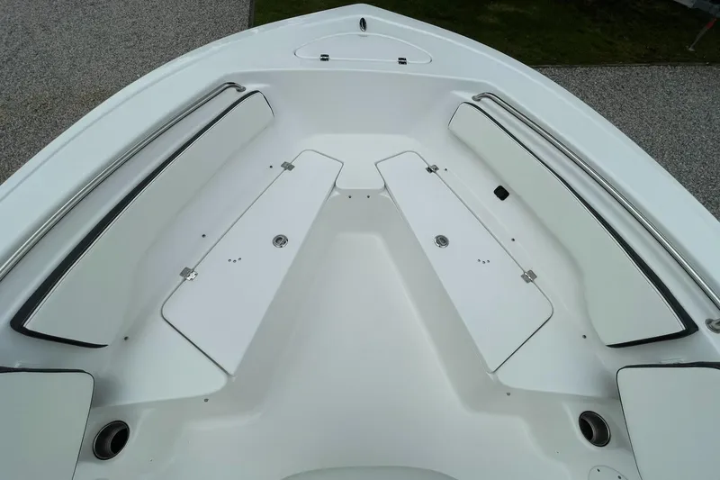Slide: The Image of 2024 Tidewater 198 CC Adventure boat interior with white seating and storage compartments. - 7